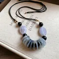Ethnic style necklace with marbled agate beads on adjustable black cord - Necklace - Transparent