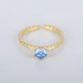 Elegant gold-plated adjustable ring featuring a brilliant round blue gemstone accent. - Adjustable Open / Light Blue Zirconia Six Claw Style (YXY-FJTR(33))