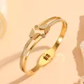 Detailed macro view of gold stainless steel double-layer butterfly bangle with rhinestones - Double Layer Butterfly (H422)