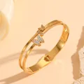 Close-up of double-layer gold stainless steel bangle with crystal butterfly detail - Double Row Butterfly (H716)