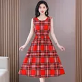 A beautiful full-length view of a red plaid sleeveless midi dress with a cinched waist. - Red White Plaid (F22)