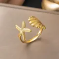 Detailed view of the 18K gold-plated starfish and seashell open ring in titanium steel - Shell and Starfish Ocean Style (F136)