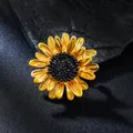 Detailed close-up of a golden enamel sunflower brooch with textured black center - Golden Daisy Style (XD825272)