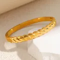 Detailed macro view of a gold titanium steel bracelet featuring irregular twisted texture - Smooth Twist Style (Gold)