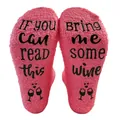 Close-up of pink coral fleece socks with 'Bring me some wine' anti-slip soles - One Size / Watermelon red