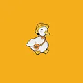 Close-up of cute white duck enamel pin with yellow hat and orange scarf detail - Straw Hat Duck