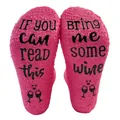 Detailed macro view of pink fuzzy floor socks with non-slip Bring Me Wine text and icons - One Size / Rose Red