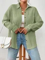 Close-up of sage green textured shirt showing drop-shoulder and button details - Light Green