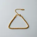 Close-up of gold stainless steel Cuban link bracelet with lobster clasp. - Cross Weave Chain (ne273) / Gold