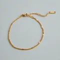 Detailed view of a gold-plated stainless steel geometric Cuban chain bracelet. - Geometric Cut Fine Chain (ne277) / Gold
