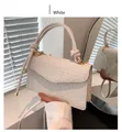 Detail of white textured crossbody bag with knotted handle and gold hardware - White
