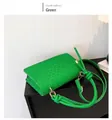 Detail shot of a vibrant green minimalist square crossbody bag with unique woven texture. - Green