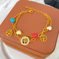 Dettaglio del bracciale a doppio strato in acciaio al titanio placcato oro 18K - Stile Albero della Vita e Perline a Cuore (X1654)