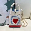 Stylish white knitted phone bag featuring a red heart motif and blue embroidery - Silicone Phone Case #15