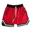Detailed view of red mesh basketball training shorts featuring secure zipper pockets - S / Red