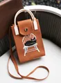 Small terracotta knitted phone bag featuring a cute cat illustration on a white chair - Silicone Phone Case #42