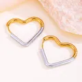 Close-up of two-tone heart-shaped gold and silver hoop earrings in titanium steel - Heart Style / 24mm / Gold and Silver Two-tone