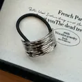 Close-up of minimalist silver textured metal alloy hair tie with durable black elastic cord - Silver Hammered Square
