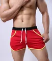 Close-up detail of men's red mesh athletic shorts with contrast yellow trim and white drawstring - M / Red