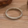 High quality minimalist silver coiled snake bone bracelet on natural wood surface - Silver Industrial Snake Bone Chain / 3495 Silver