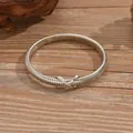 Silver snake bone choker necklace with elegant criss-cross clasp on wood background - Silver Cross Knot Snake Choker / 3501 Silver