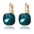 Detailed close-up of square emerald green crystal earrings in gold leverback setting - Green