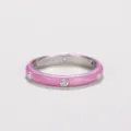Macro detail of a minimalist pink enamel ring featuring sparkling cubic zirconia stones - Pink
