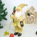 Detailed view of champagne gold Santa Claus figurine with lantern for Christmas decor - Gold Red Santa Claus