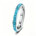 Stainless steel eternity ring featuring light blue crystals in a channel setting - Cyan