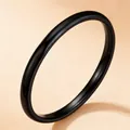 Minimalist black stainless steel band ring featuring a glossy polished finish. - Size 5 / Black Inner and Outer Ball (27-D-2)
