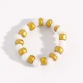 Detailed top view of a white and gold acrylic beaded ring on a white surface - White and Gold Style (11869)