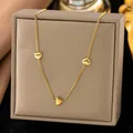 Elegant gold titanium steel necklace featuring three heart charms on a jewelry box - Three Hearts (H1208)