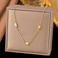 Elegant gold-tone titanium steel necklace featuring three polished heart-shaped charms. - Three Hearts (H1193)