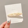 Elegant cream marble acrylic hair clip displayed on a white Korean brand card - Apricot Milk