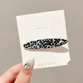 Chic black and white cow print duckbill hair clip for women on a white display card - Black Polka Dot