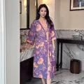 Elegant purple floral cotton gauze bathrobe for women shown in a luxurious bathroom. - Light Wind Purple
