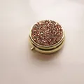 Elegant round gold metal pill box featuring a sparkling rhinestone lid for travel use - Gold - Rose Gold Rhinestone