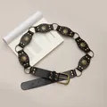 Detail view of black Bohemian belt with vintage bronze rivets and metal ring connectors. - Rivet Metal Disc Belt (X1074-1) / Black