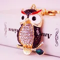 Exquisite rhinestone-encrusted owl keychain with gold-tone finish and enamel leaf detail - Black Owl Style (1184)
