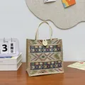 Ethnic style woven tote bag with tribal patterns and white button closure detail. - Khaki
