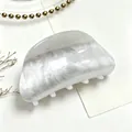 Detail view of white marble texture on a medium acrylic shark hair claw clip - White