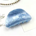 Close-up of blue water ripple acrylic hair claw clip with elegant marble texture. - Glaze Blue