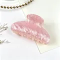 Macro detail of pink water ripple acrylic hair claw clip with pearlescent texture - Pink