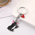 Detailed macro view of cute waving black French Bulldog keychain with red heart charm - French Bulldog / 10cm