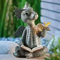 Whimsical resin dragon garden statue reading a book featuring a glowing butterfly accent - Reading Dragon
