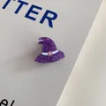 Macro view of purple glitter witch hat hair claw clip for Halloween accessory. - Witch Hat