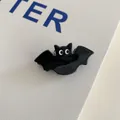 Close-up of a cute black bat acrylic hair claw clip for Halloween party accessory - Small Bat Clip