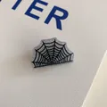 Macro view of silver glitter spider web acrylic hair claw clip for Halloween. - Spider Web Clip