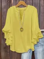 Macro view of yellow V-neck blouse featuring tiered ruffle sleeves and necklace accessory - Yellow