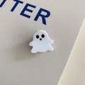 Close-up view of a minimalist white acrylic ghost hair claw clip for Halloween. - Little White Ghost Clip
